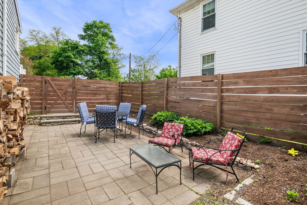 8 Baker Avenue Beverly, MA 01915 - Photo 30 of 40 a view of a chairs and table in the back yard of the house