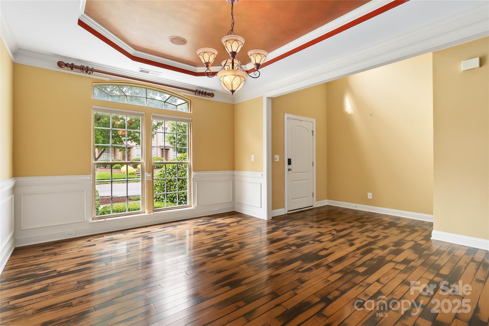 2346 Donnington Lane Northwest Concord, NC 28027 - Photo 2 of 5 a view of an empty room with a window and wooden floor