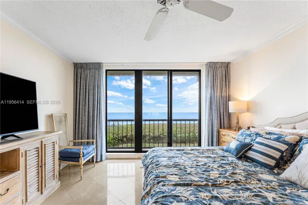 a bedroom with a bed and a flat tv screen
