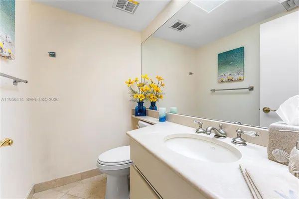a bathroom with a sink toilet and mirror