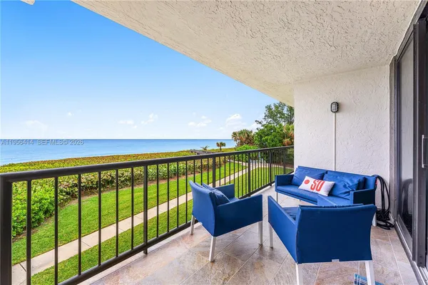 a balcony with couch and outdoor view