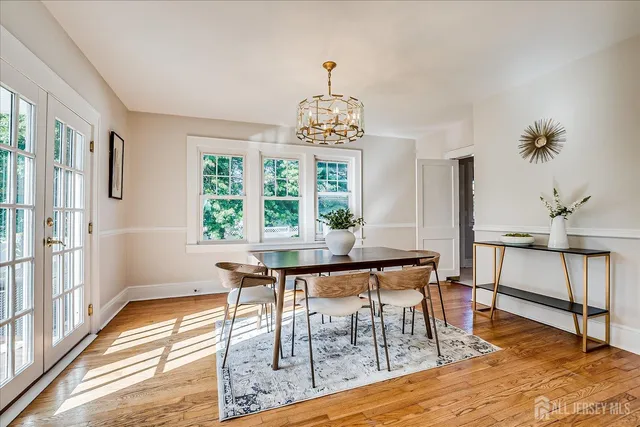 a view of a dining room with furniture wooden floor and a chandelier