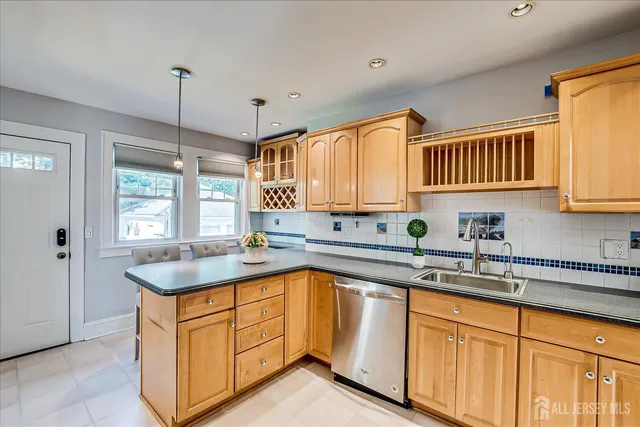 a kitchen with stainless steel appliances a stove sink and cabinets