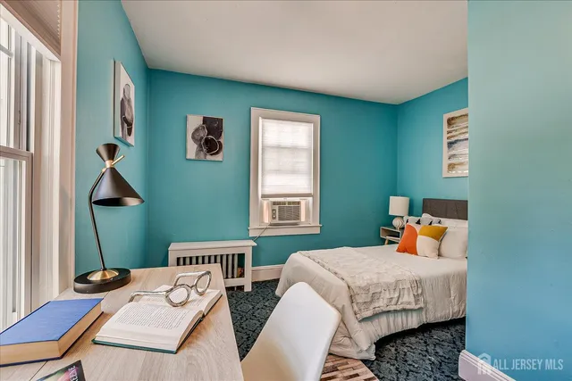 a bedroom with a bed and window