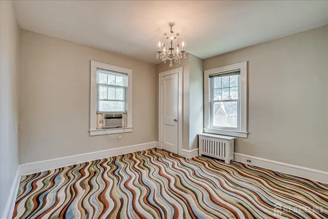 a bedroom with bed and window