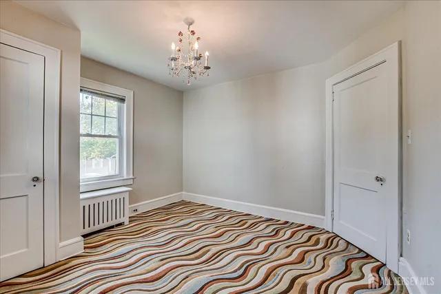 a view of room with workspace and wooden floor