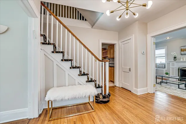 a view of a livingroom with wooden floor and staircase