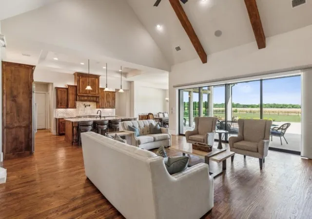 a living room with furniture and large windows