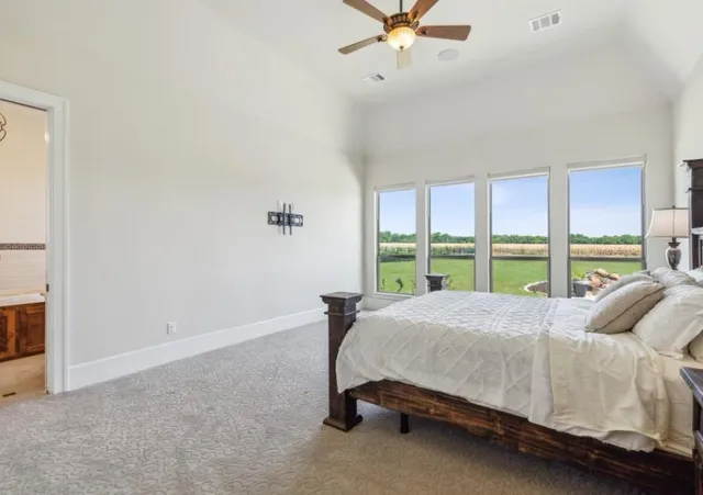 a bed sitting in a bedroom next to a window