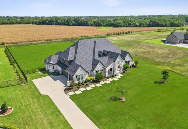 a view of a house with a yard and lake view