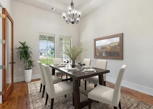 a view of a dining room with furniture a chandelier and wooden floor