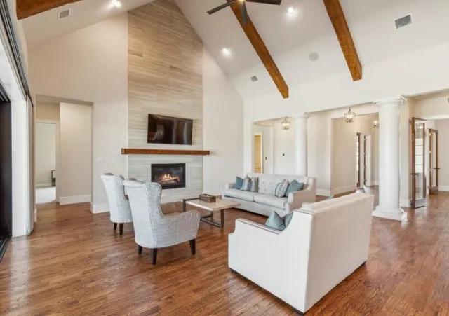a living room with fireplace furniture and a flat screen tv