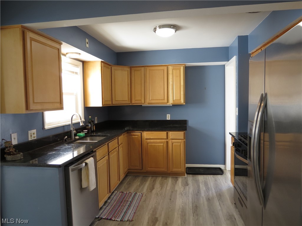 641 Schocalog Road Akron, OH 44320 - Photo 15 of 33 Kitchen featuring granite counters and vinyl flooring