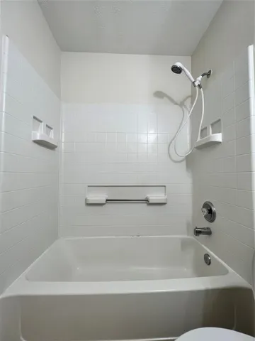 a bathroom with a bath tub and a shower