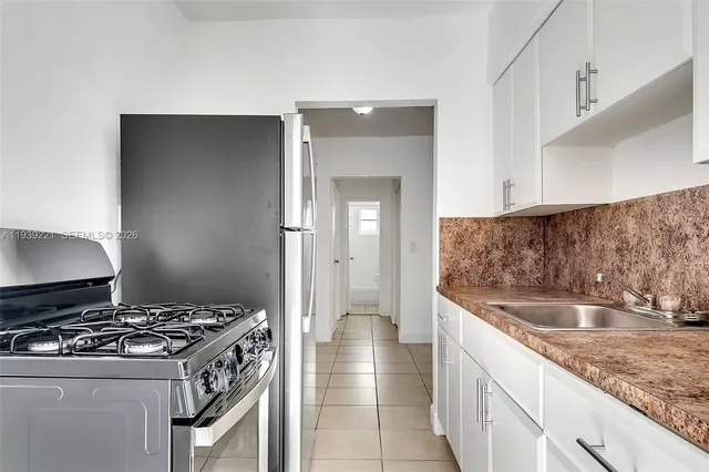 a stove top oven sitting inside of a kitchen