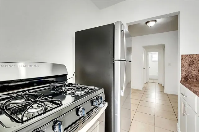 a kitchen with a refrigerator and a sink