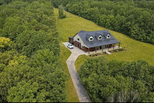 a aerial view of a house with a yard