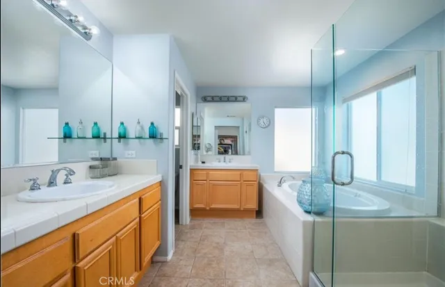 a bathroom with a granite countertop sink mirror and bathtub