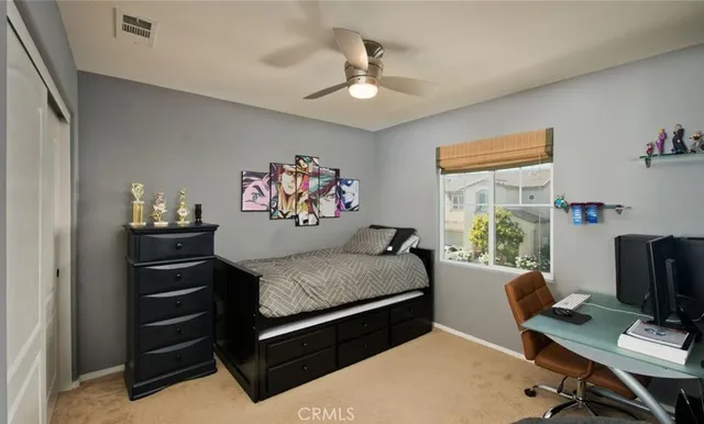 a bedroom with a bed and a desk