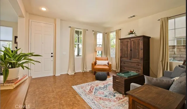 a living room with furniture and a potted plant