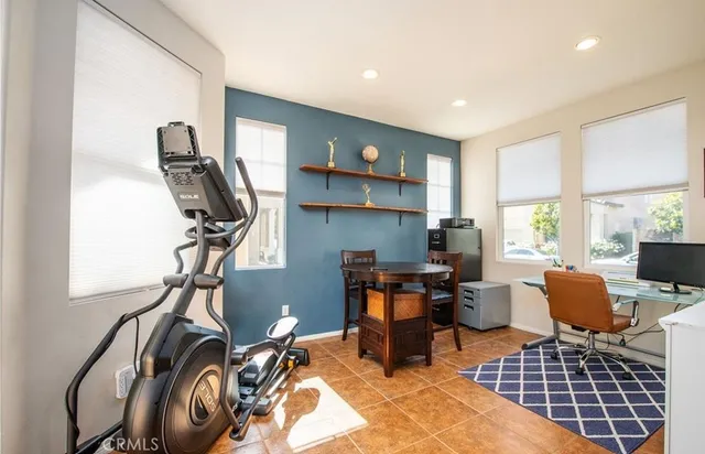 a view of a workspace with furniture and a window