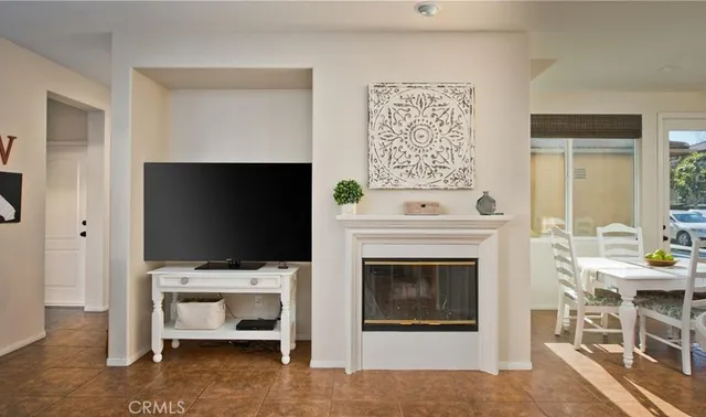 a living room with a flat screen tv a rug and white walls