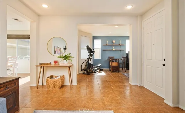 a living room with furniture and a mirror