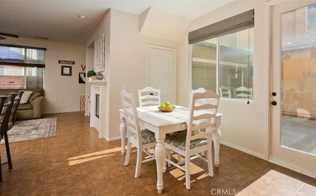 a dining room with furniture and window