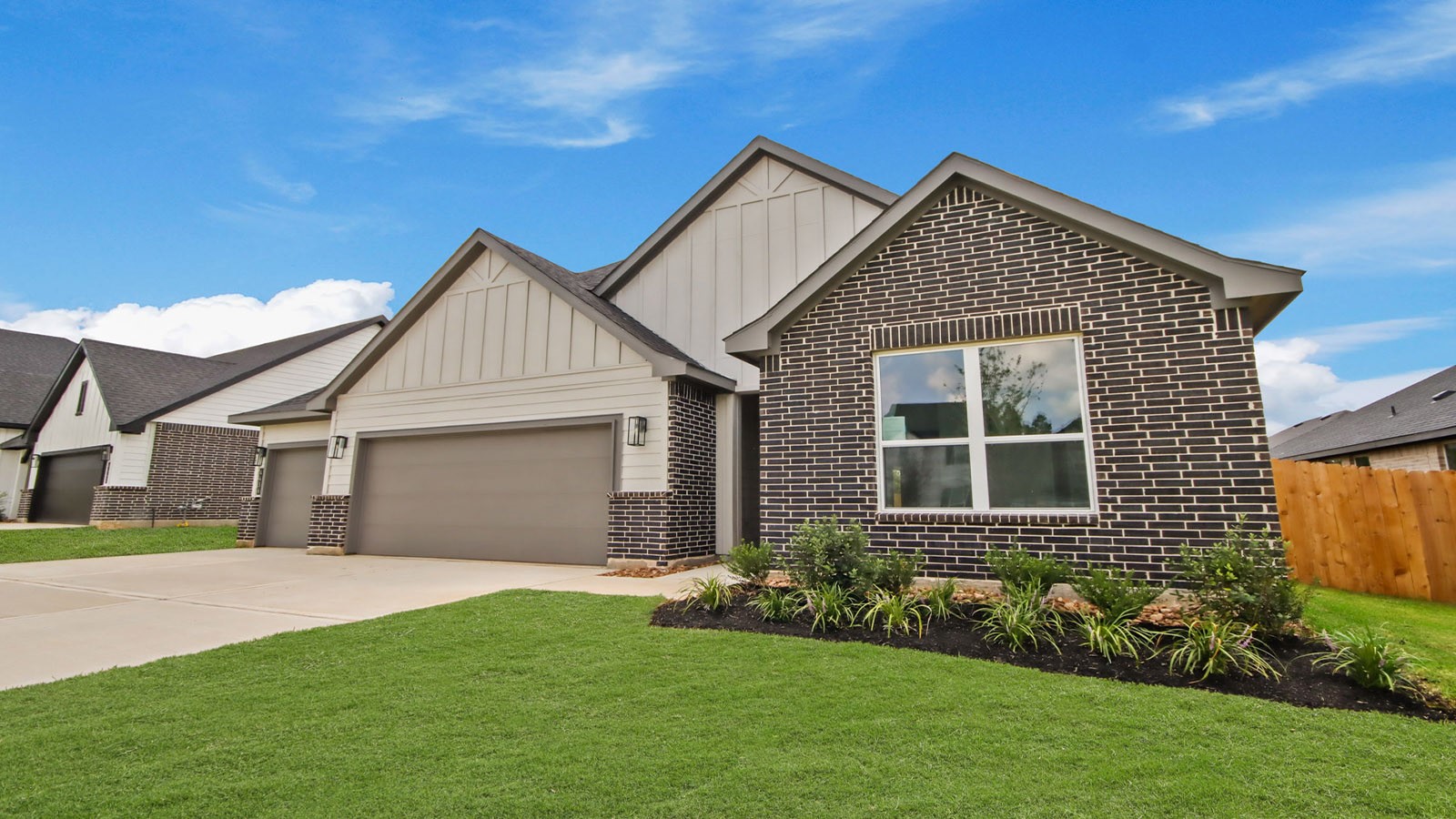 4436 Wapama Falls Loop Conroe, TX 77303 - Photo 2 of 39 a front view of a house with a garden and yard