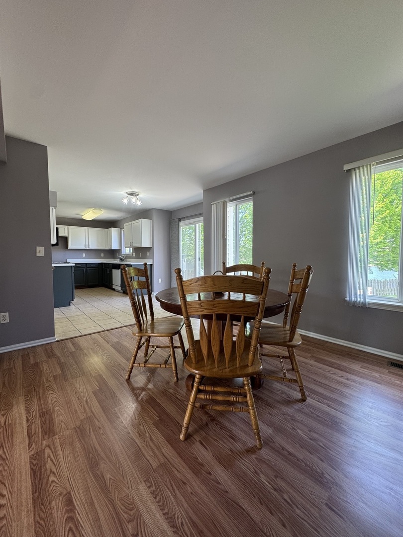 1716 William Drive Romeoville, IL 60446 - Photo 6 of 18 a view of a dining room with furniture and wooden floor