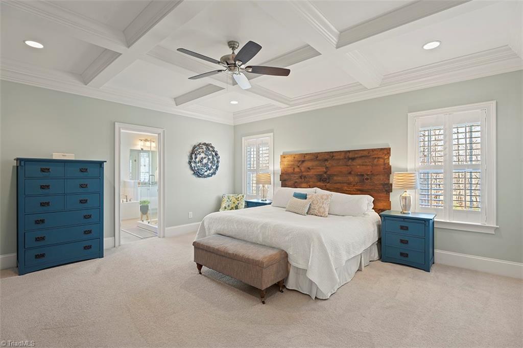 6370 Gumwood Road Oak Ridge, NC 27310 - Photo 14 of 47 Primary bedroom has plantation shutters and coffered ceiling