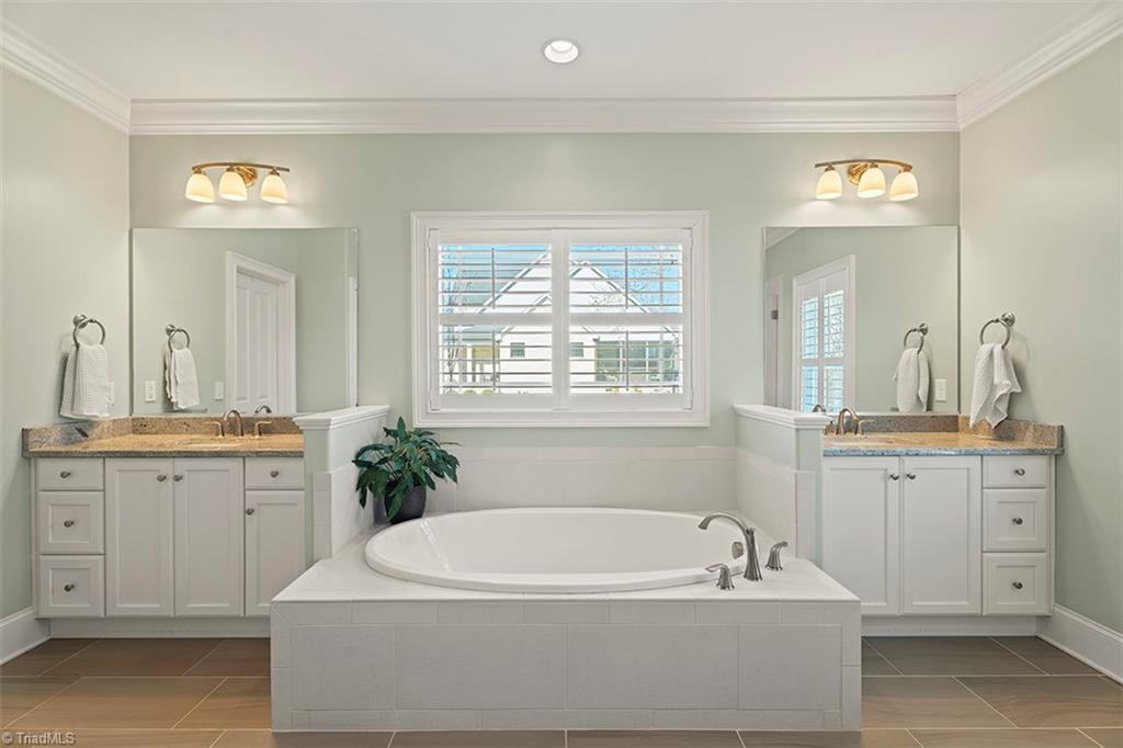 6370 Gumwood Road Oak Ridge, NC 27310 - Photo 16 of 47 Primary bathroom with dual sinks and plantation shutters