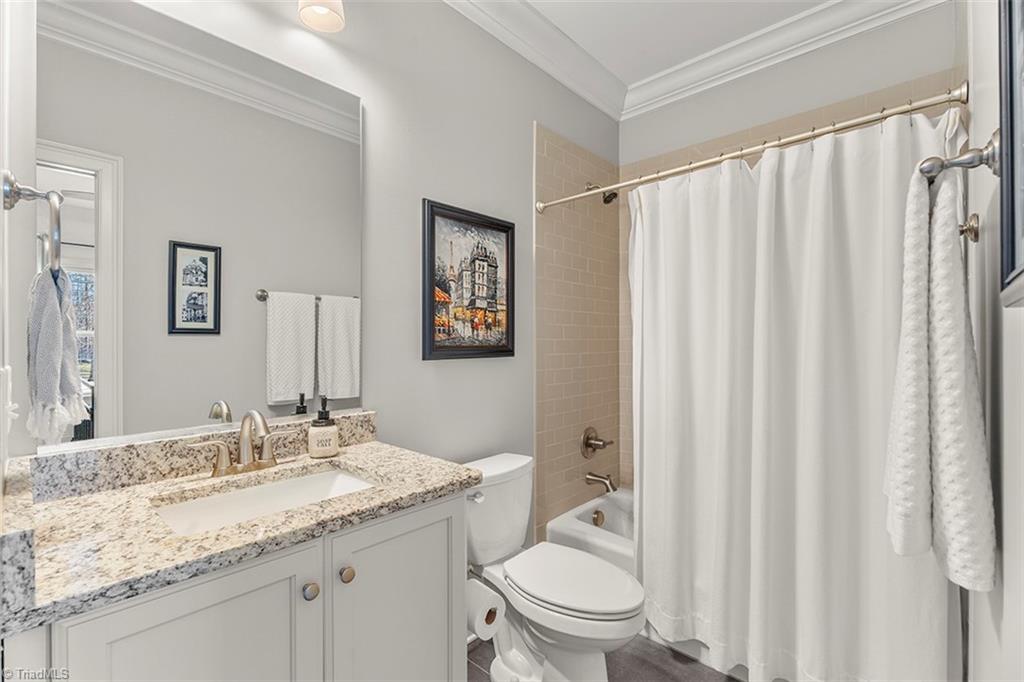 6370 Gumwood Road Oak Ridge, NC 27310 - Photo 35 of 47 Main level bathroom- adjoins to secondary bedroom and off of the kitchen