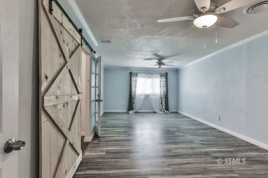 1415 Mayo Street Ridgecrest, CA 93555 - Photo 21 of 34 a view of an empty room with wooden floor and staircase