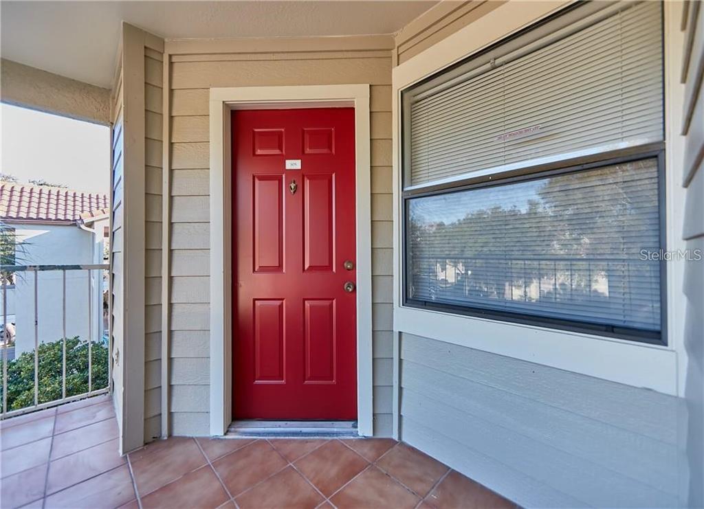 3032 Parkway Boulevard, Unit 305 Kissimmee, FL 34747 - Photo 2 of 40 a view of a red door of the house