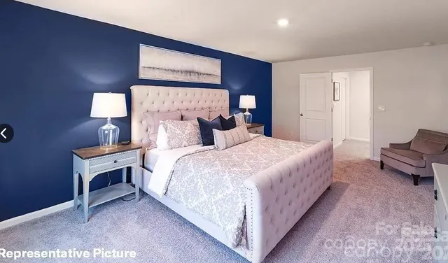 a bedroom with a bed and a lamp