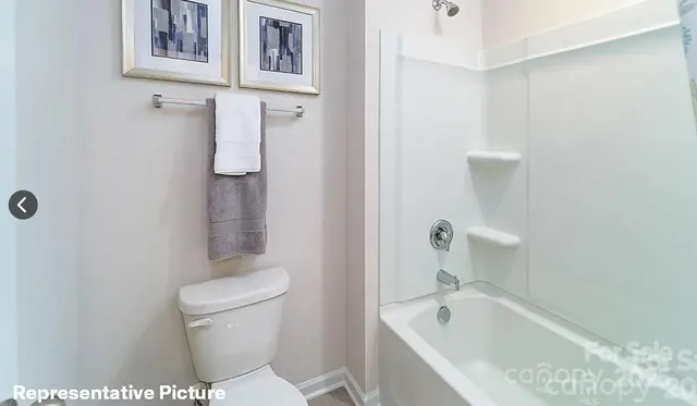 a bathroom with a toilet and a bathtub
