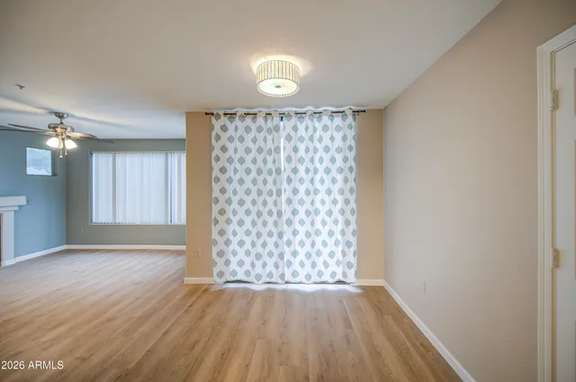 a view of an empty room with a fireplace and a window