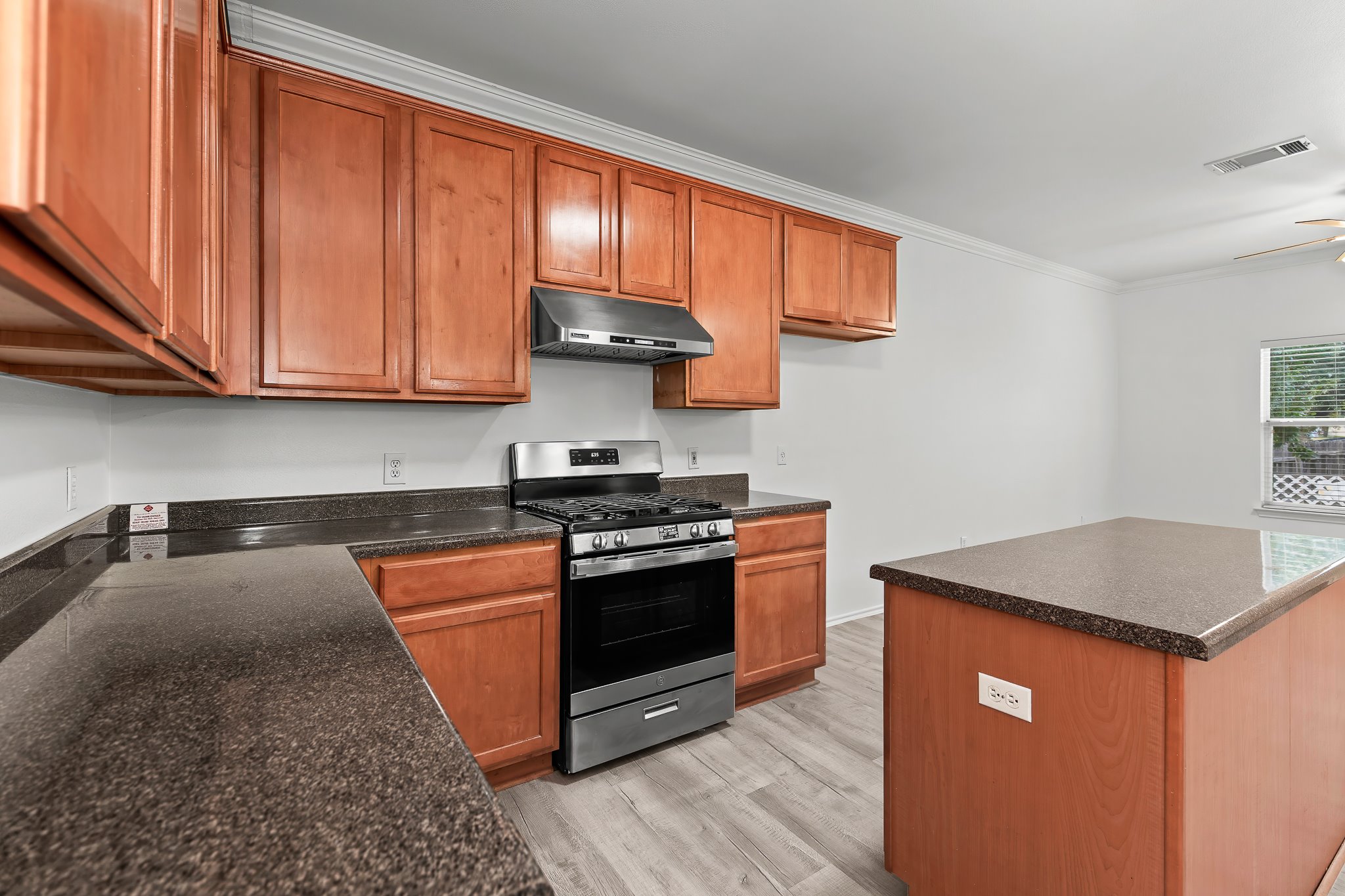 6700 Tulloch Way Austin, TX 78754 - Photo 12 of 39 a kitchen with stainless steel appliances granite countertop a stove a sink and a microwave