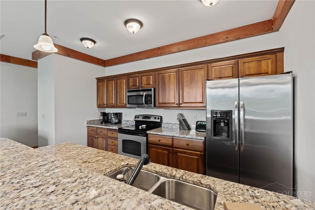 142 Evening View Lane, Unit CA3 Boone, NC 28607 - Photo 9 of 41 a kitchen with stainless steel appliances kitchen island granite countertop a refrigerator and a stove top oven