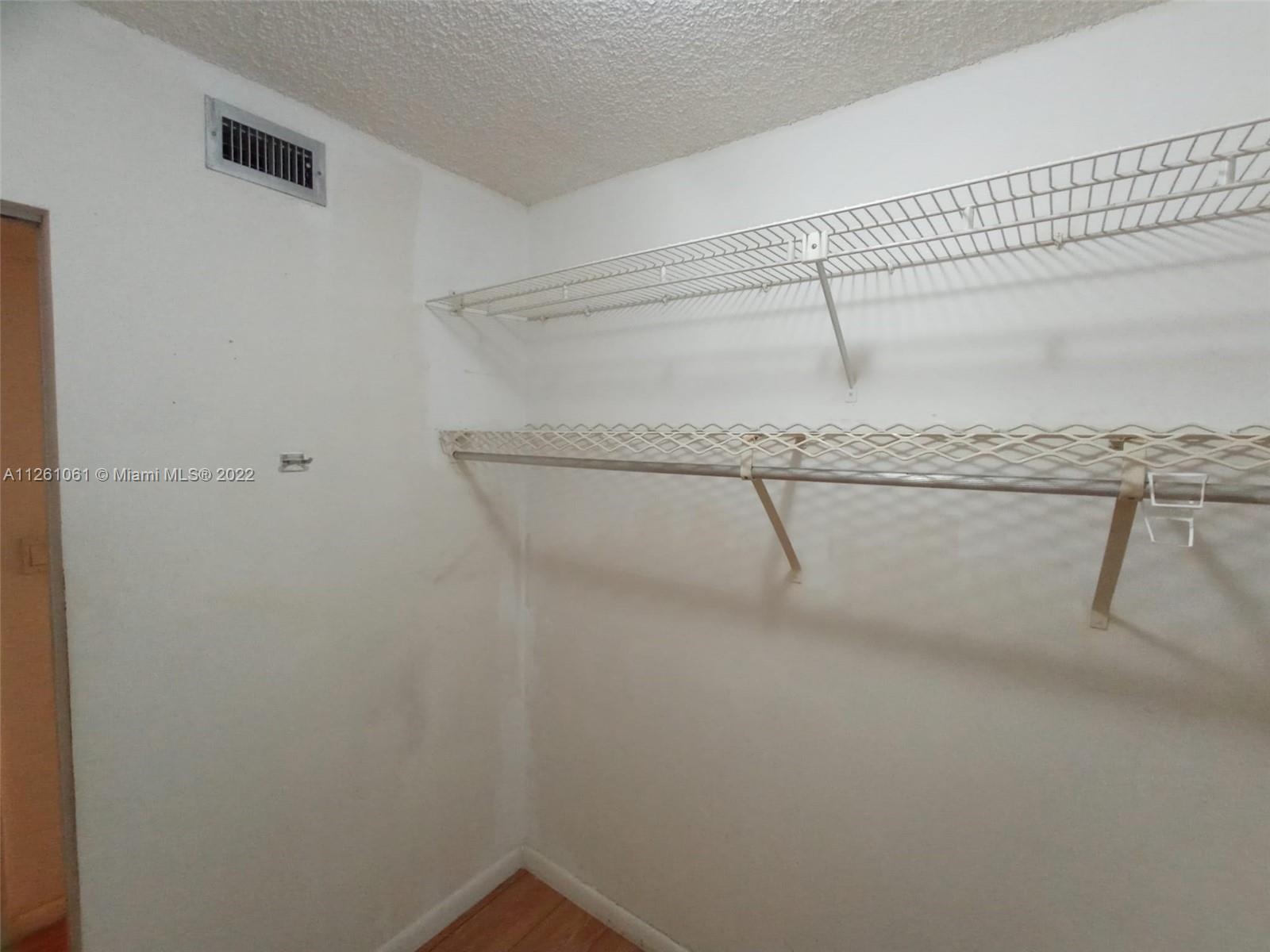 Cypress Bend Pompano Beach, FL 33069 - Photo 25 of 31 a view of a room with racks on the wall