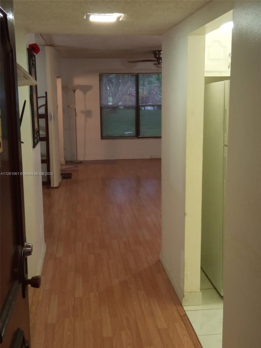 Cypress Bend Pompano Beach, FL 33069 - Photo 27 of 31 a view of a hallway with wooden shelves
