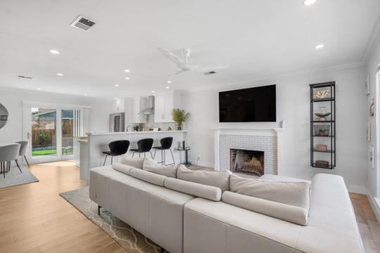 1364 Bouret Drive San Jose, CA 95118 - Photo 5 of 35 a living room with furniture a fireplace and a flat screen tv