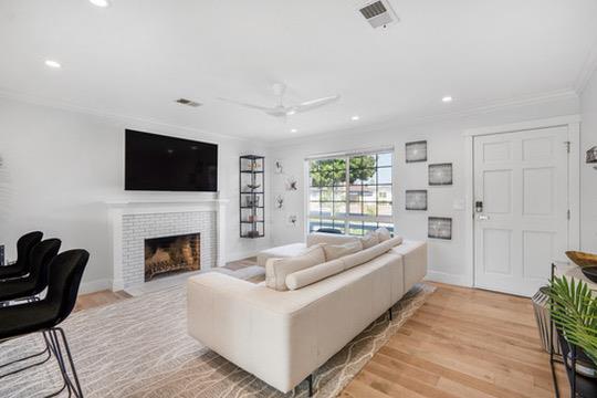 1364 Bouret Drive San Jose, CA 95118 - Photo 6 of 35 a living room with furniture a fireplace and a flat screen tv