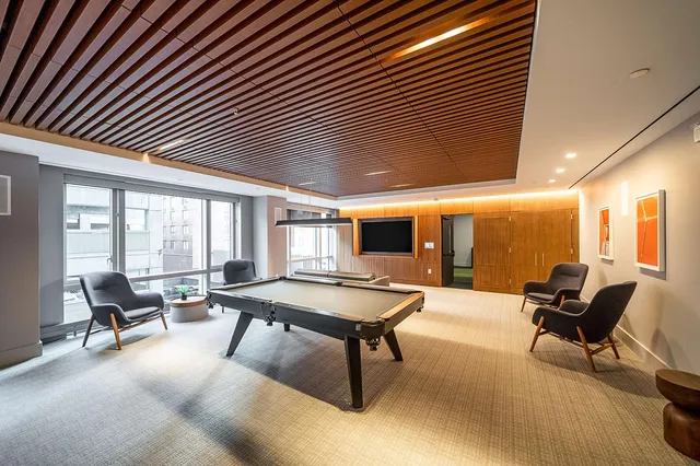 a living room with furniture a rug and a chandelier