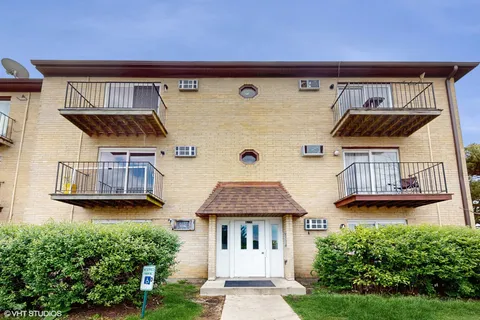 a front view of a house with roof deck and garden