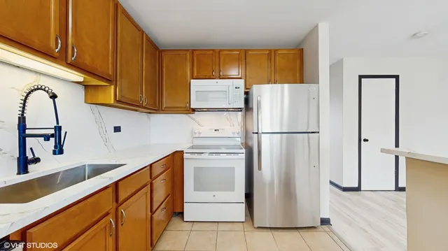 a white refrigerator freezer sitting in a kitchen