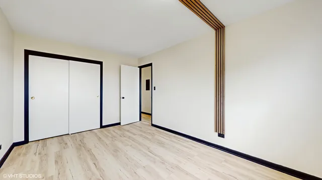 a view of a room with wooden floor and white walls