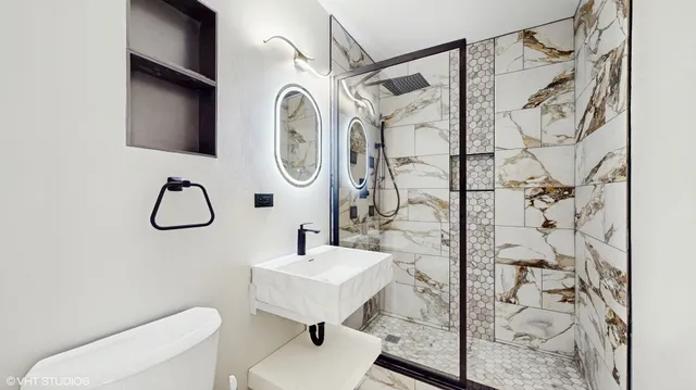 a bathroom with a toilet sink and shower curtain