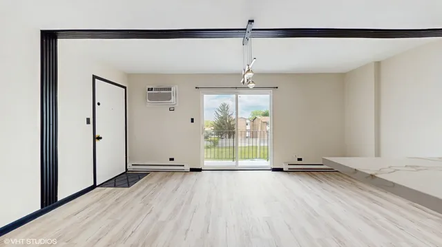 a view of a room with wooden floor wooden floor and windows